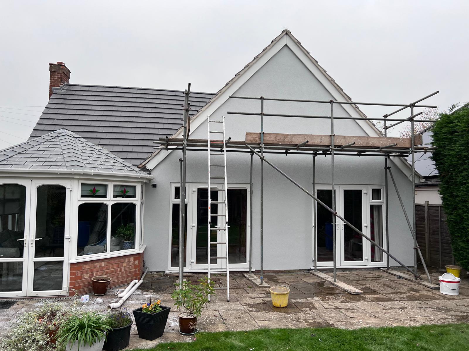 After: rear render finished, conservatory tied in