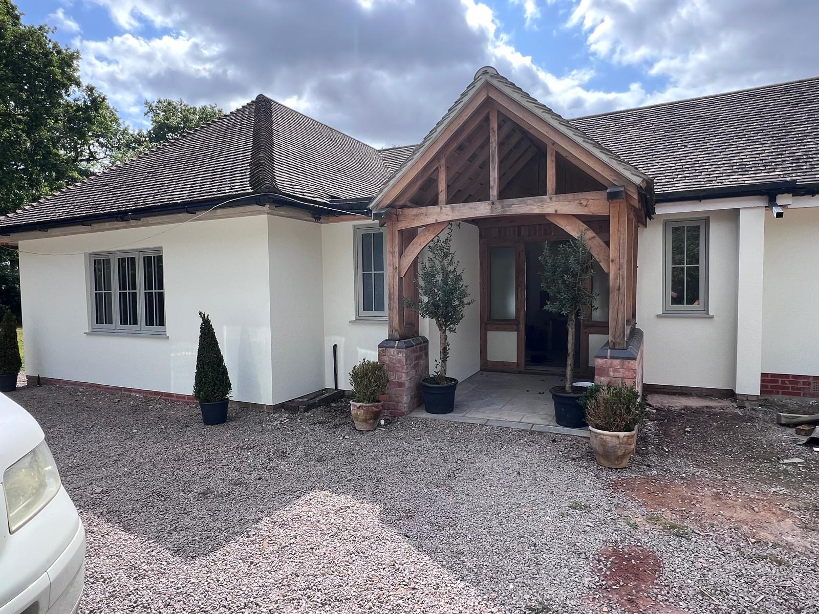 After: smooth white silicone render with bifold doors