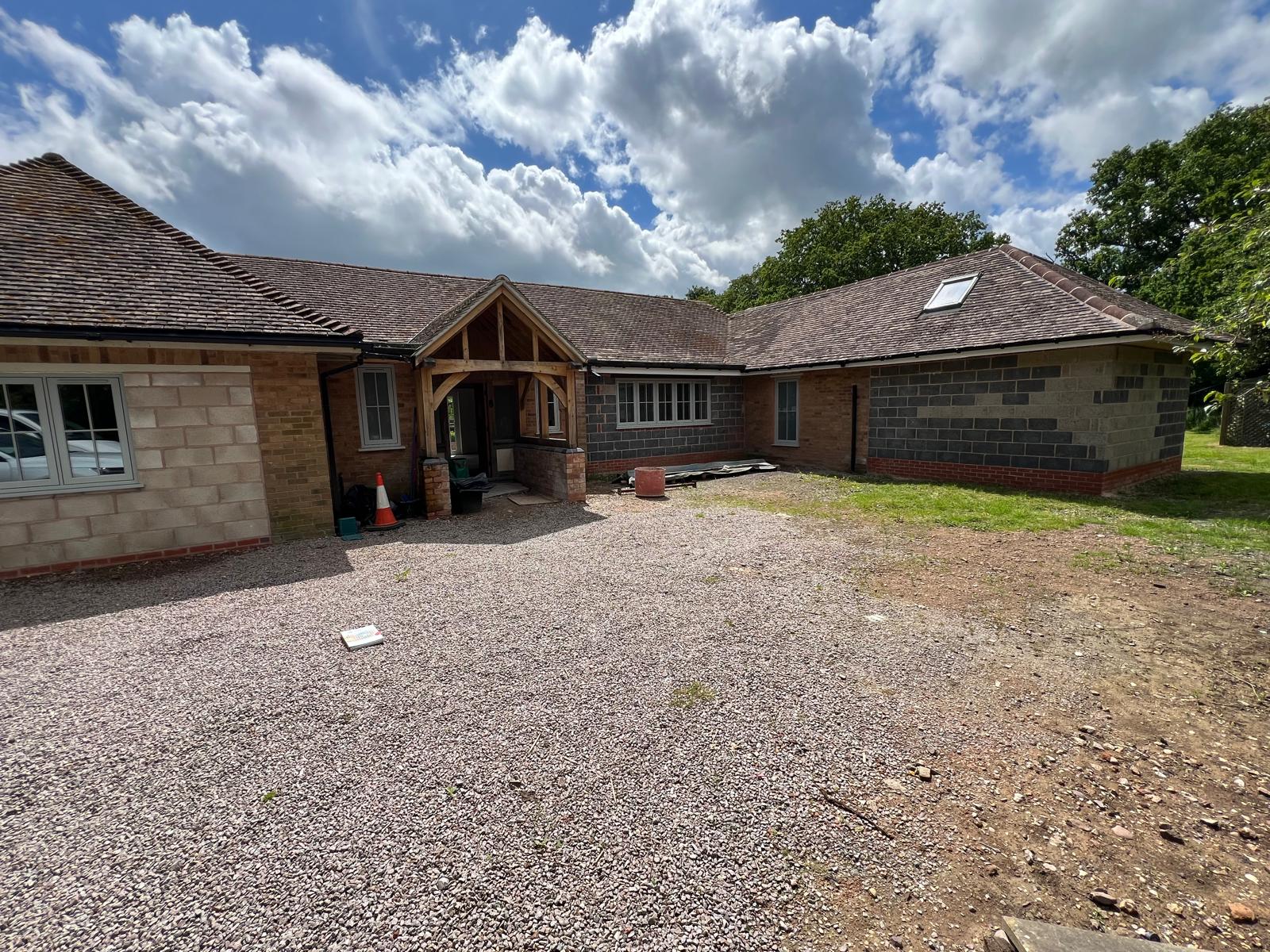 Before: bare grey blockwork at the rear of the bungalow