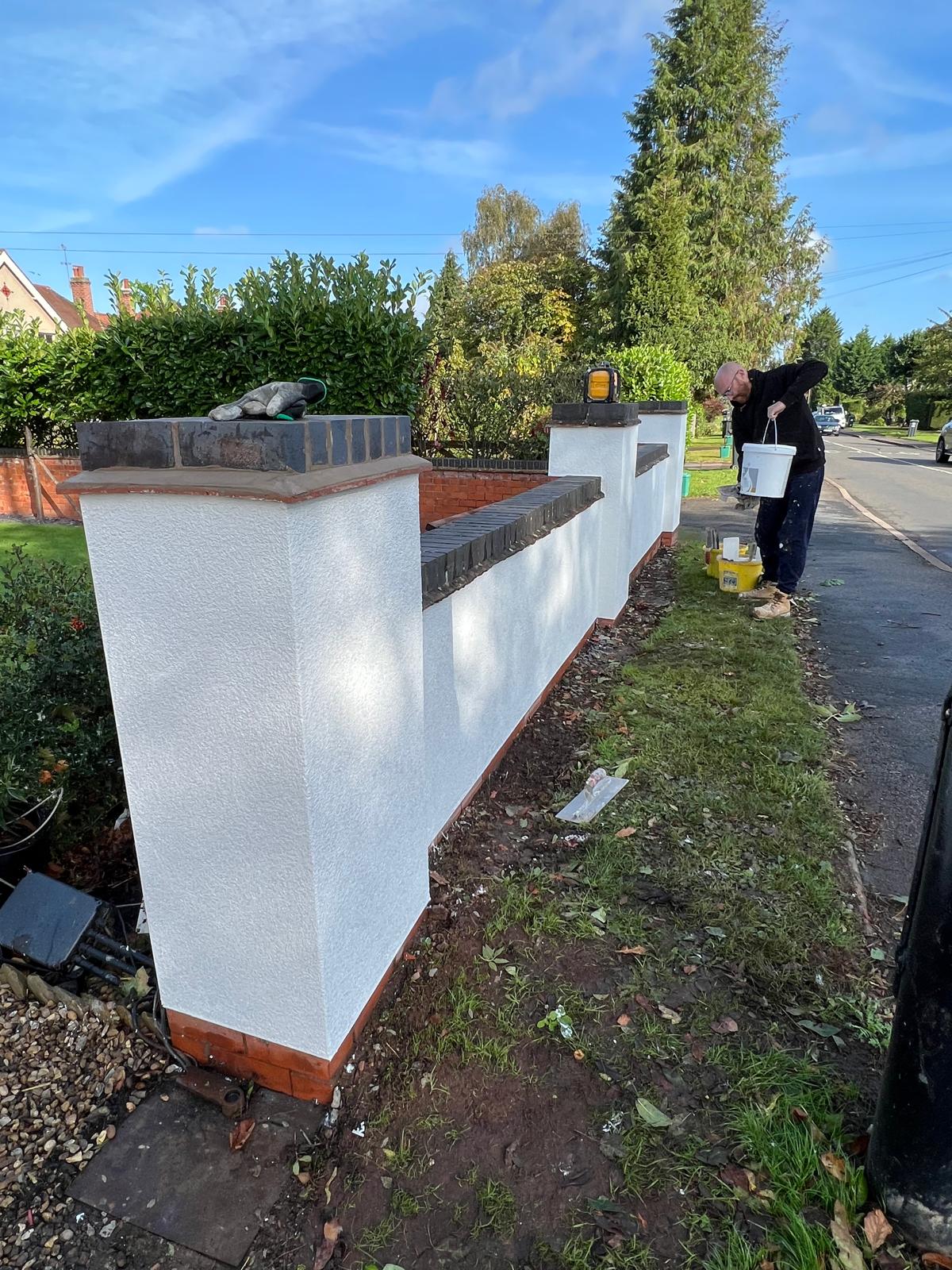 After: rendered garden wall with brick piers and stone copings