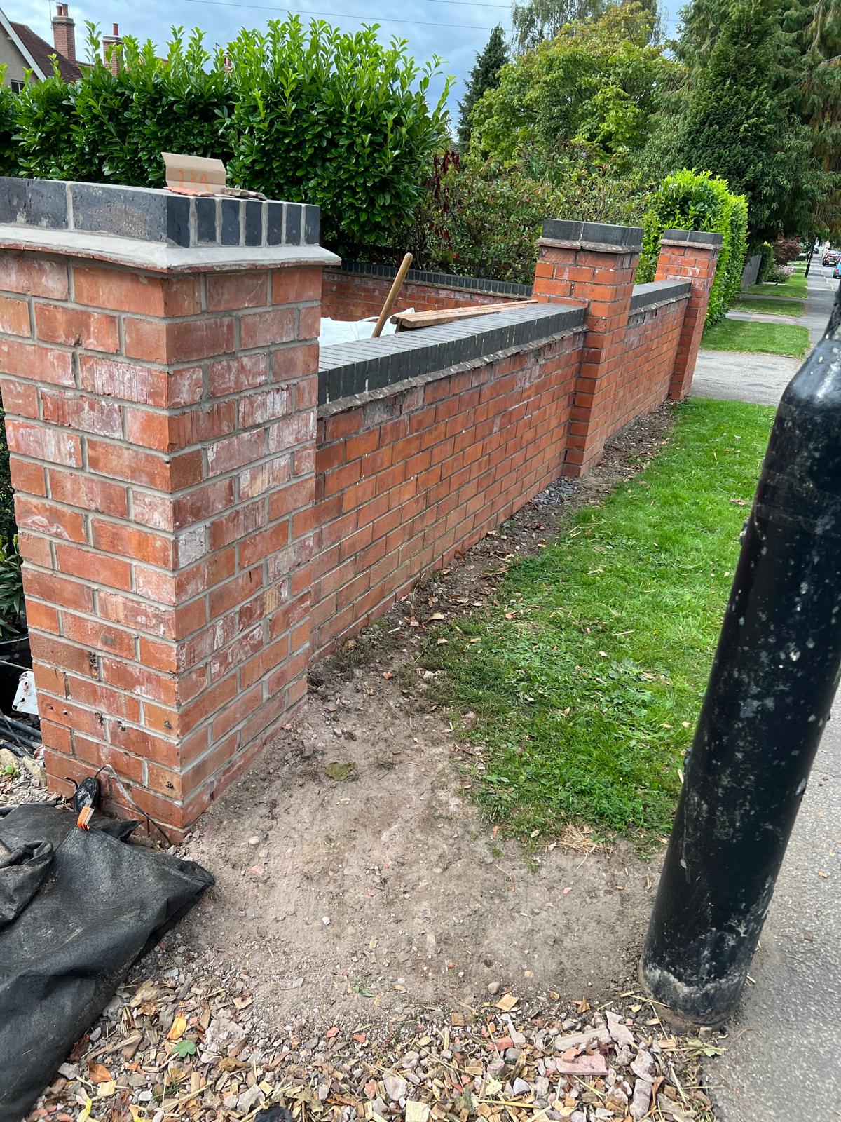 Before: original brick boundary wall and copings, pre-render
